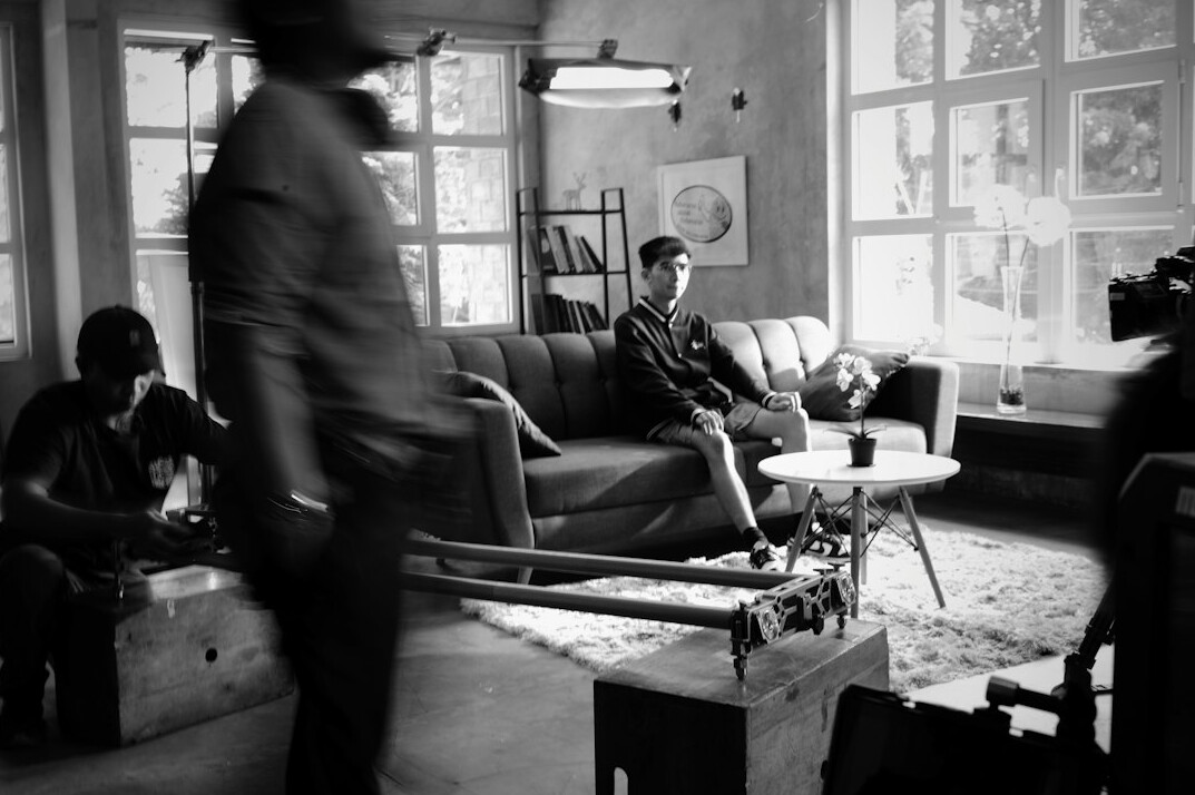 Vintage television studio set with camera crew filming a commercial in the 1980s